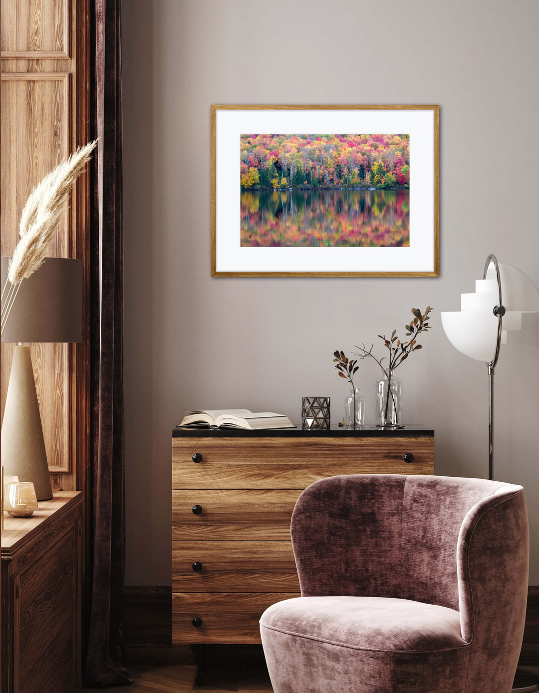 Decorative room interior with a framed artwork, wooden dresser, and purple chair.